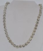 A white metal budda bead necklace with l