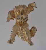 A vintage brooch in the form of a dog wi