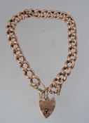 A 9ct gold gormette chain link bracelet with heart lock clasp with etched decoration to links with