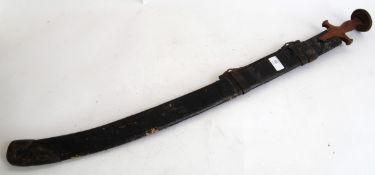 MIDDLE EAST SWORD: An unusual middle eastern sword with shaped roundel handle set within full