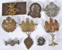BADGES: A good collection of 10x assorted vintage military uniform badges to include a white metal