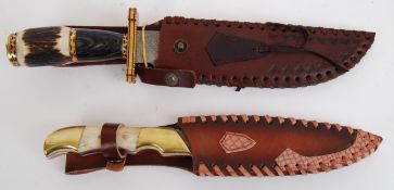 KNIVES: A pair of 20th century Damascus bladed hunting knives - both with horn or faux horn handles