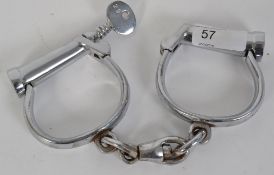HANDCUFFS: An original pair of early 20th century Hiatt ' D ' policeman's handcuffs.