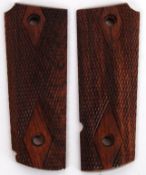 COLT 45: A pair of Colt 45 pistol gun walnut grips. Each intricately carved.