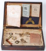 MILITARIA: A box of assorted militaria to include a Civil Defence armband in blue,