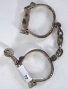 HANDCUFFS: An original pair of early 20th century Hiatt ' D ' policeman's handcuffs.