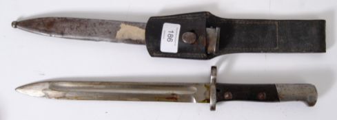 BAYONET: A Polish Mauser bayonet, OE over WG to the ricasso. 08184 stamped to scabbard.