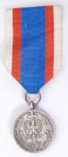 MEDAL OF MERIT; An original Polish Medal Of Merit medal, bronze. With ribbon.