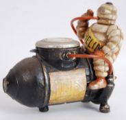 MICHELIN MAN: A vintage style reproduction Michelin Man sat on a tyre compressor machine mascot