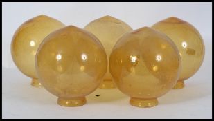 A collection of vintage yellow glass globes - shades being 5 in total ( see illustrations )