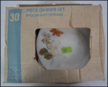 A retro unused Pyrex style dinner service,