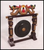 A large 20th century oriental Chinese decorated gong, complete with stand and beater.