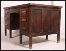 An Air Ministry type twin pedestal desk being raised on squared legs with flared top and a series