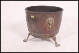 A Regency large copper and brass coal - log bucket of oval - cauldron shape form with lion mask