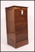 An early 20th Century Industrial oak pedestal office filing cabinet having a rising tambour front,