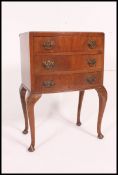 A Georgian style mahogany bow front bedside chest of drawers being raised on cabriole legs with pad