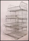 A pair of vintage 20th century large metal racks - industrial shop stands of wire metal work form.