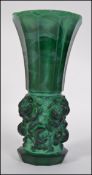 An unusual large Victorian green glass vase having trumpet form top on cylindrical body.