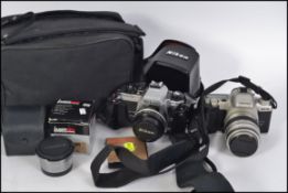 CAMERAS: Nikon 35 mm camera FG-20 plus a couple of lenses along with a 35 mm Pentax camera,