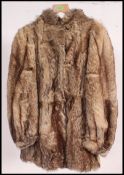 A vintage 3/4 length believed to be Wolf fur coat, having a black satin lining,