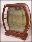 A mid century walnut china display cabinet of round form having twin sliding doors with gilded