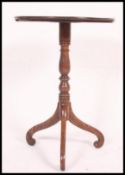 A 19th century mahogany tripod wine table raised on splayed leg base,