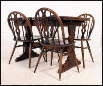 An early Ercol dark wood draw leaf refectory dining table together with a set of Ercol Windsor type