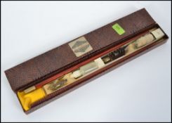 A cased 20th century Leslie Hewett gun / rifle cleaning kit, complete with contents in box.