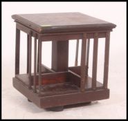 A small table top Victorian oak revolving bookcase raised on hidden quadruped base Each side with