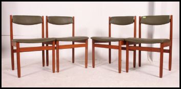 A set of 4 good 1970's teak dining chairs having original green faux leather pad seats and back