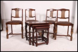 A set of 4 Ercol dark wood dining chairs with walnut back rests on turned legs with pad feet,