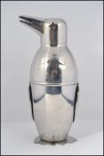 A silver plated novelty cocktail shaker in the form of a penguin having,