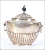 An Edwardian silver hallmarked lion mask handled sugar bowl with hinged lid.