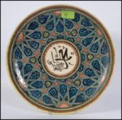 Azim Kutahya - a elaborately decorated hand painted Islamic art plate signed, Azim Kutahya to base,