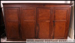 A stunning large 19th century pine estate / school cupboard.