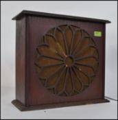 A vintage wooden early 20th century radio having speaker front,