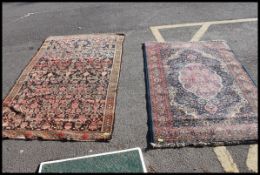 A large handwoven Persian rug with black and red ground,