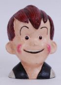 A 20th century cast iron hand painted money box in the form of a smiling boy.
