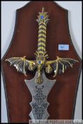 A Medieval style replica steel bladed broad sword with gilt hex and dragon cross guard and handle