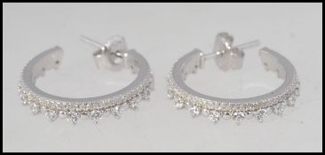 A pair of contemporary ladies silver cz hoop / creole earrings complete with studs.