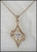 A gilded silver and cz pierced lozenge pendant and silver necklace complete in the presentation
