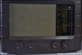 A vintage early 20th century Pye bakelite valve radio with decorative facia