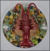 A Majolica plate with applied lobster and clams.