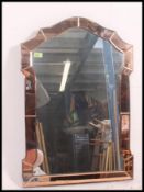 A 1930's Art Deco peach glass mirror of Venetian form the central mirror with peach glass panelled