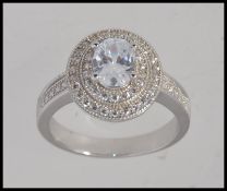 A contemporary ladies silver cz double roundel formed cocktail / dress ring with cz adorned borders.