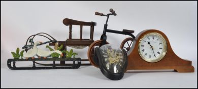 A mixed lot to include wooden dolls tricycle and slay along with a cast iron coat pegs in the form