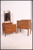 A 1930's oak dressing table chest of drawers together with a matching chest of drawers,
