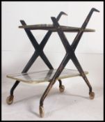 A retro 1970's two tier serving butlers trolley with angular ebonised frame having melamine faux