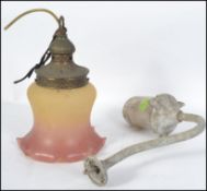 A vintage 20th century Industrial dairy lamp on shaped arm with glass shade together with a