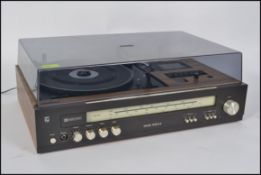 A retro Philips record , tape and radio player finished with a faux teak and brushed steel affect.